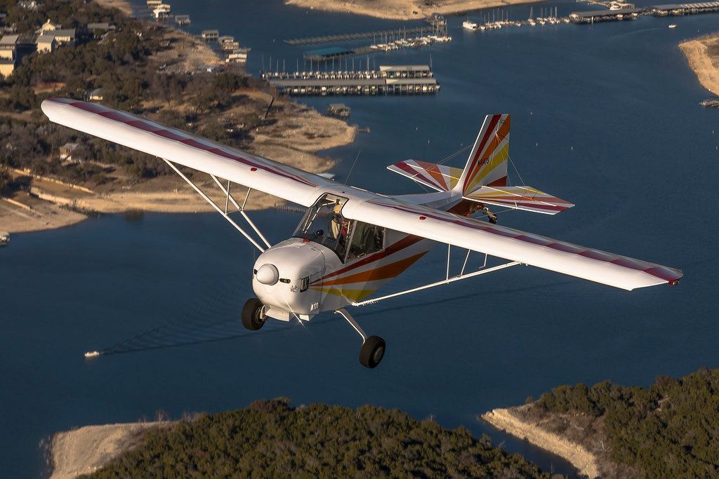 Carlson Sparrow Sport Special in flight over a lake